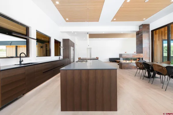 a living room with furniture pool table and a fireplace
