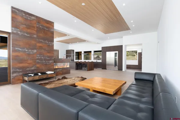 a living room with furniture and a lamp