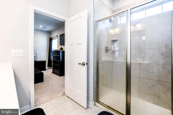 a kitchen with stainless steel appliances kitchen island granite countertop a table chairs and a refrigerator