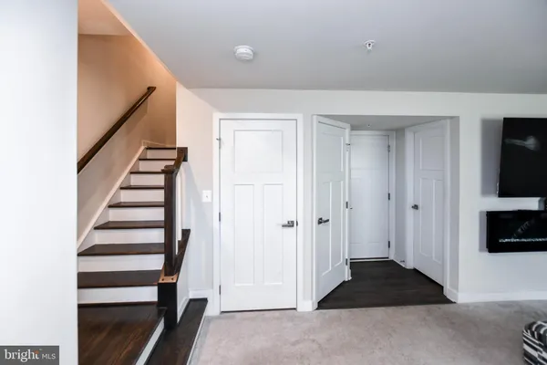 a view of a livingroom with wooden floor and white walls