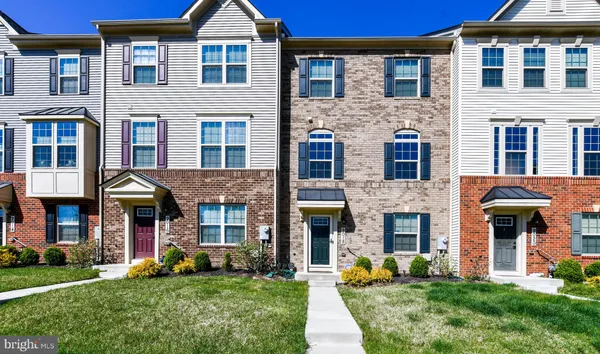 a front view of a brick house with a yard
