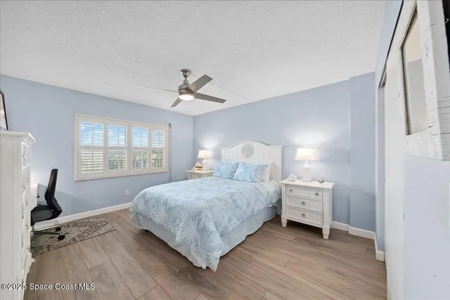 a spacious bathroom with a granite countertop sink a toilet and a mirror