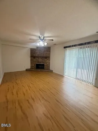 wooden floor in an empty room with a chandelier