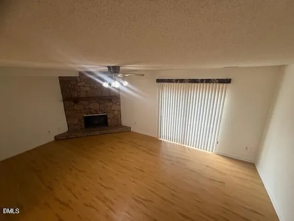 a view of empty room with a fireplace
