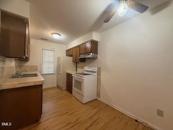 a kitchen with a sink cabinets and stainless steel appliances