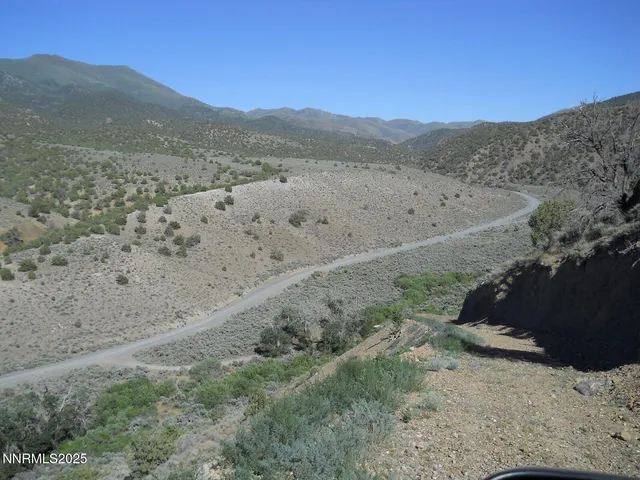 a view of mountain with sunset in background