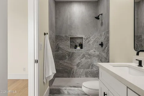 a bathroom with a sink toilet and shower