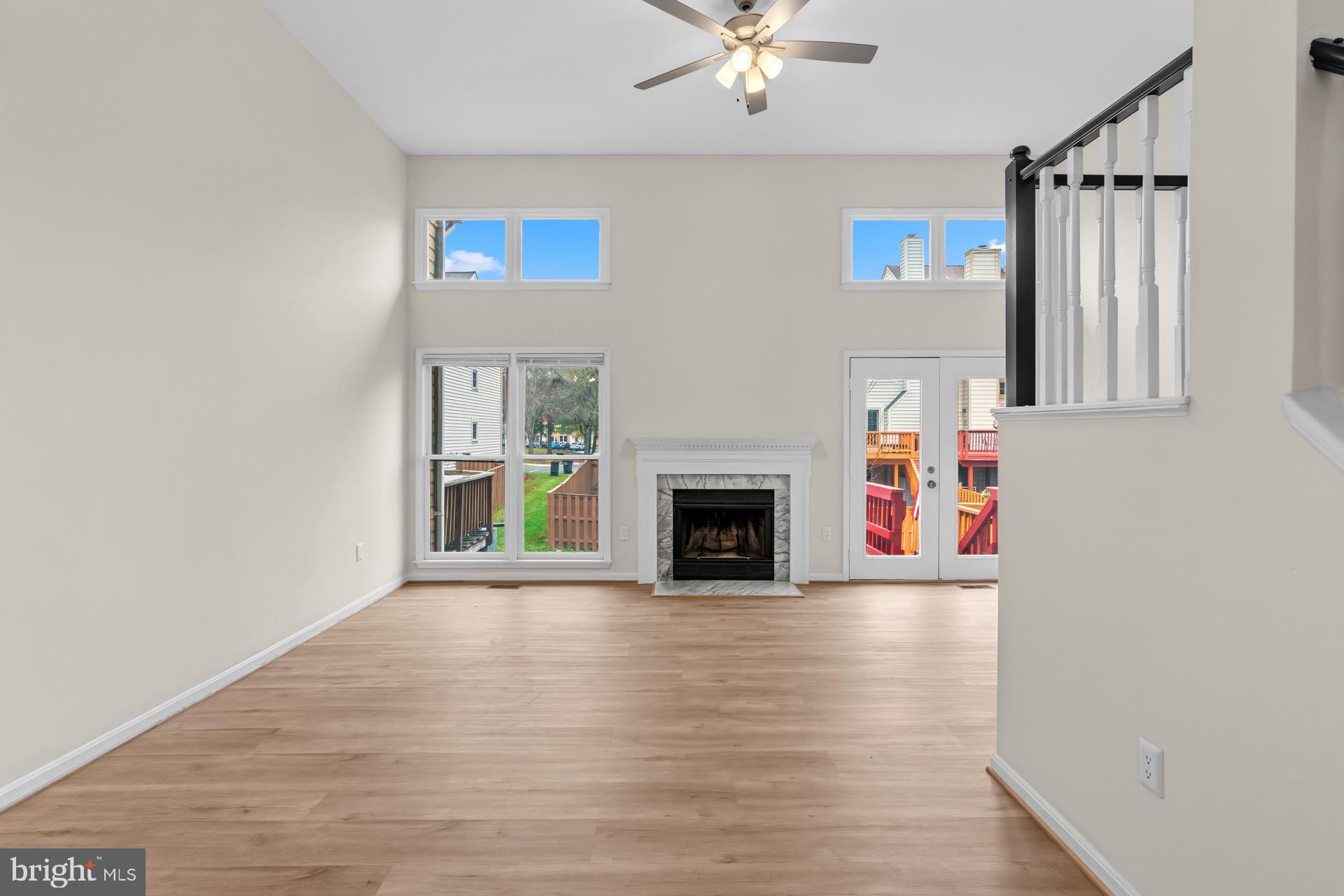 13920 Baton Rouge Court Centreville, VA 20121 - Photo 11 of 45 a view of a livingroom with a fireplace a chandelier and wooden floor