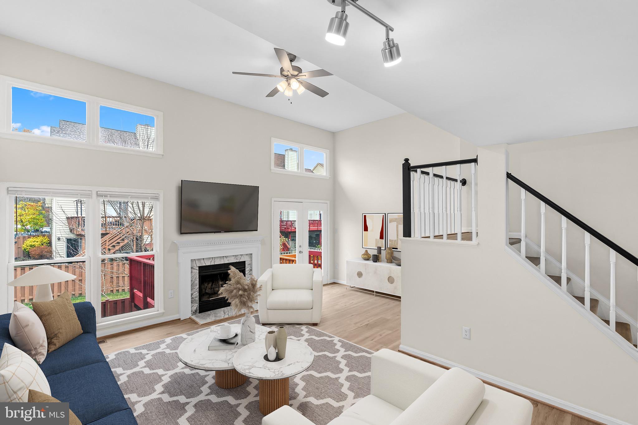 13920 Baton Rouge Court Centreville, VA 20121 - Photo 12 of 45 a living room with furniture a fireplace and a flat screen tv