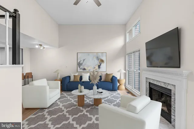 a living room with fireplace furniture and a flat screen tv