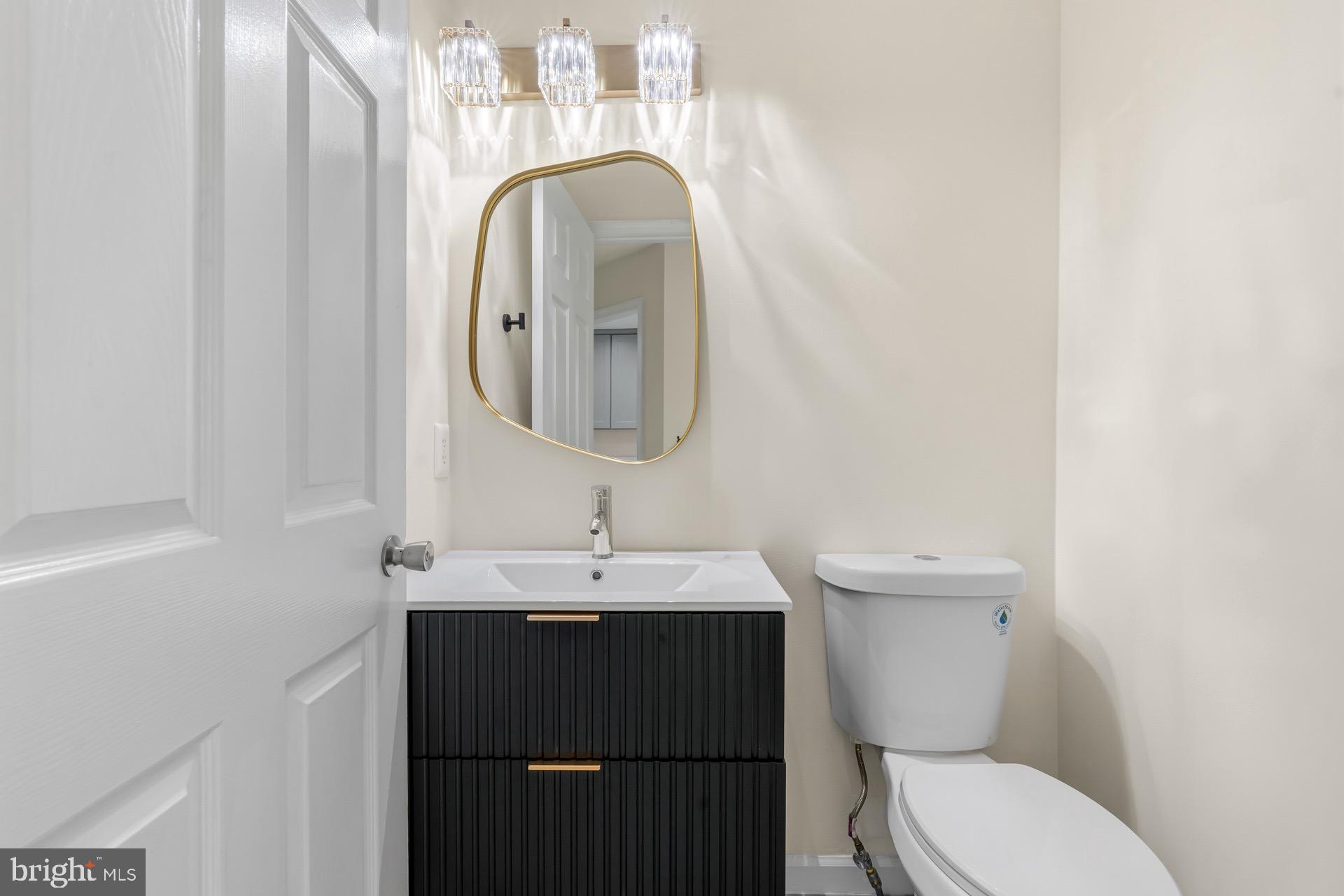 13920 Baton Rouge Court Centreville, VA 20121 - Photo 16 of 45 a bathroom with a toilet sink and mirror