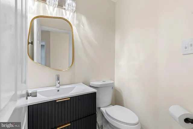 a bathroom with a toilet a sink and mirror