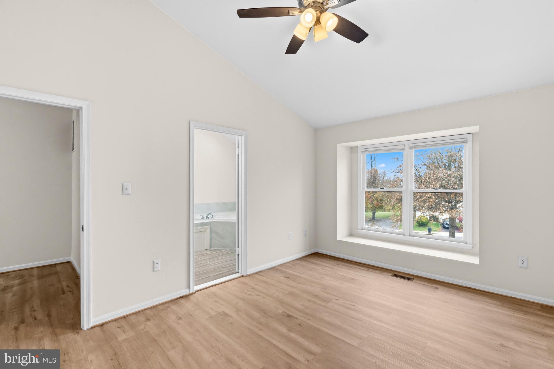 13920 Baton Rouge Court Centreville, VA 20121 - Photo 18 of 45 an empty room with wooden floor fan and windows