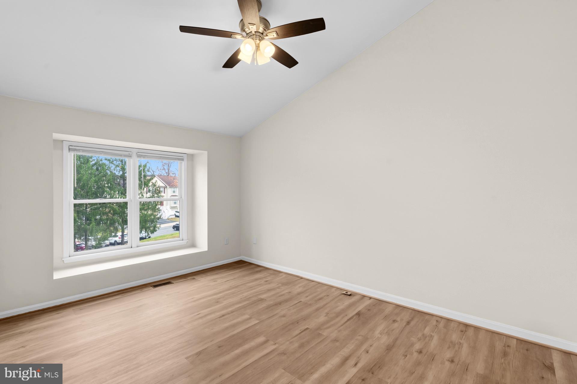 13920 Baton Rouge Court Centreville, VA 20121 - Photo 20 of 45 an empty room with wooden floor fan and windows
