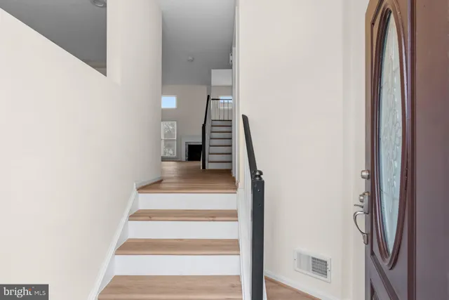 a view of entryway and hall with wooden floor