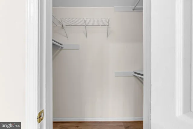 a view of walk in closet with empty racks