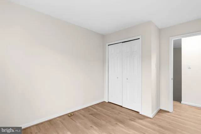 a view of an empty room and wooden floor