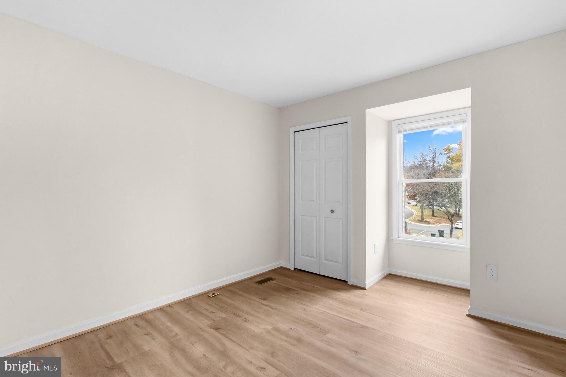 13920 Baton Rouge Court Centreville, VA 20121 - Photo 30 of 45 an empty room with wooden floor and window