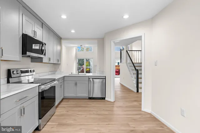 a kitchen with a sink cabinets and stainless steel appliances