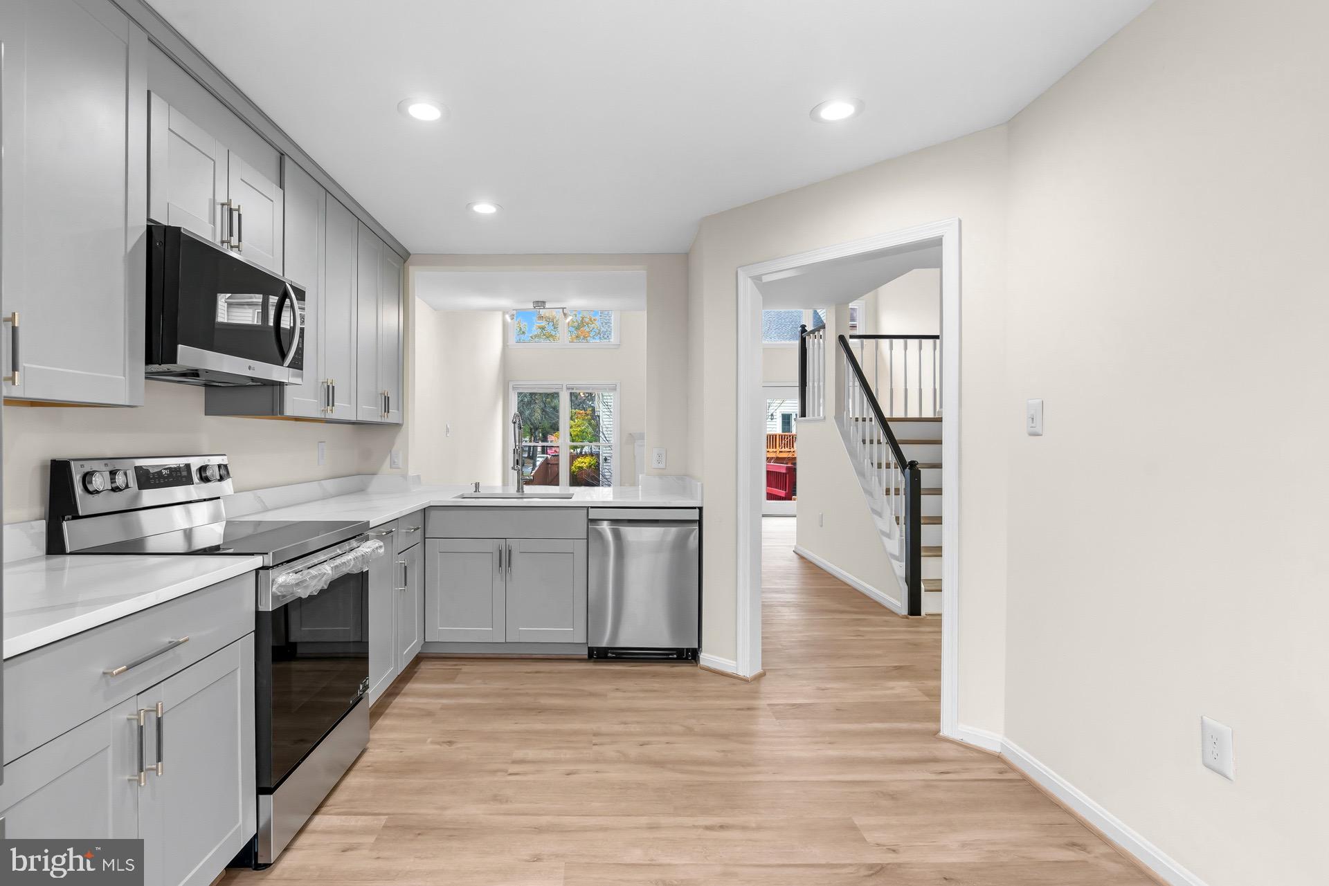 13920 Baton Rouge Court Centreville, VA 20121 - Photo 4 of 45 a kitchen with a sink cabinets and stainless steel appliances