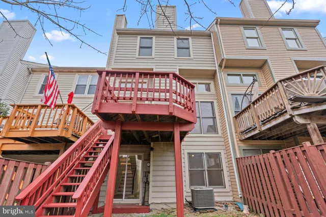 a view of a balcony with tall trees