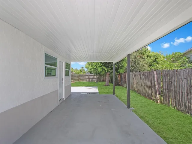 a view of a backyard with wooden fence
