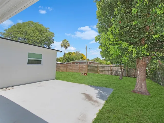 a view of a backyard with large trees