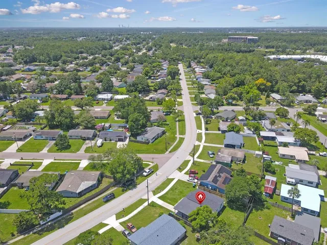 an aerial view of residential houses with outdoor space and swimming pool