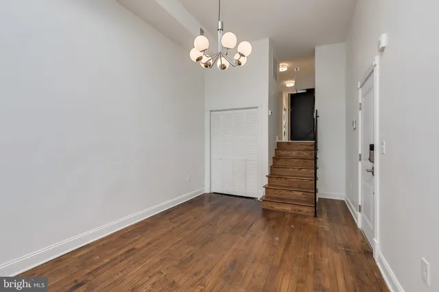 a view of a room with wooden floor and staircase