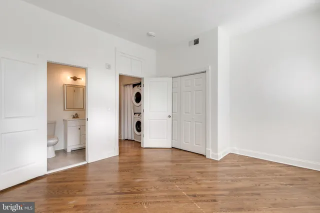 a view of empty room with wooden floor