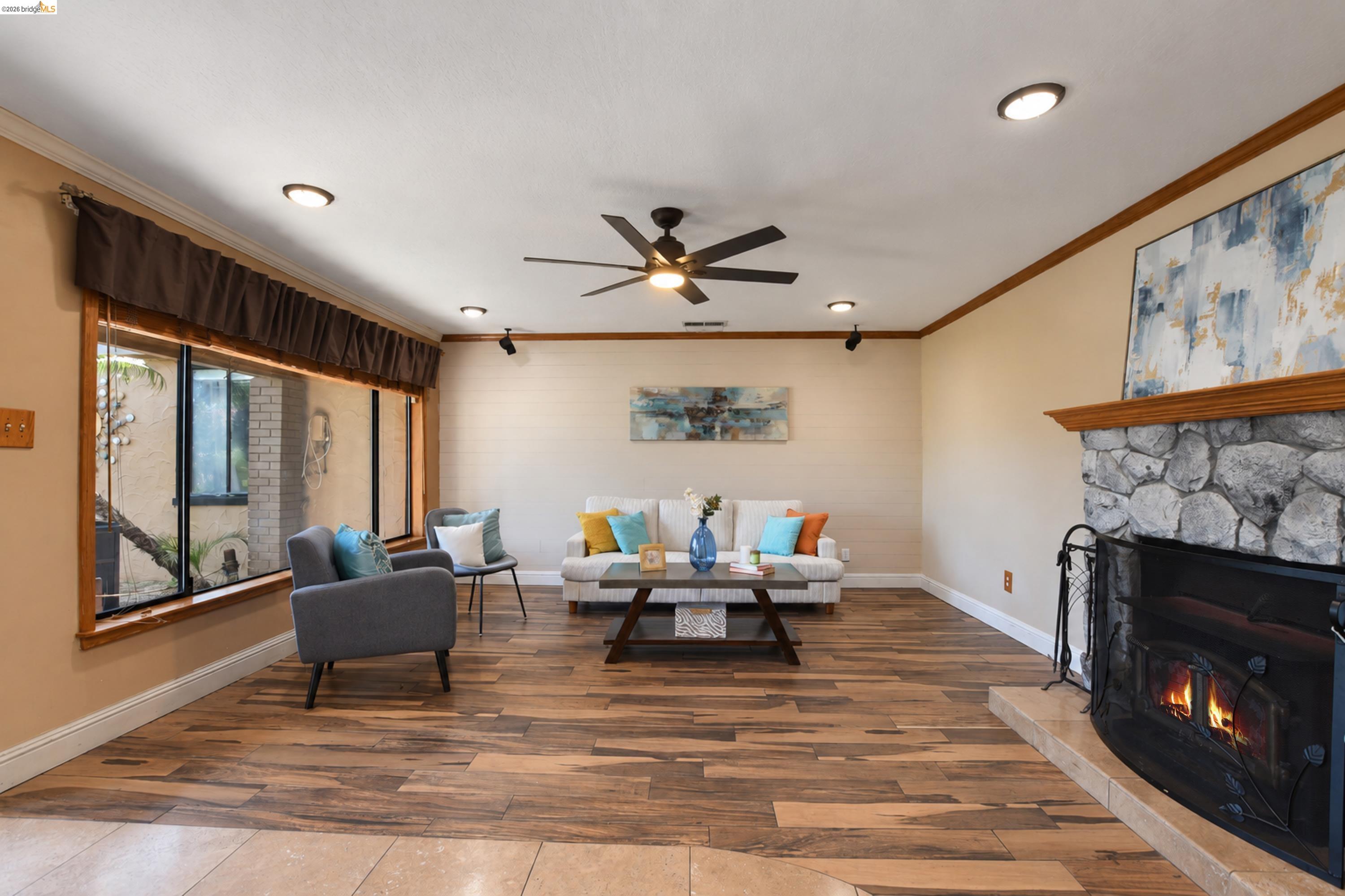 340 West Bolton Road Oakley, CA 94561 - Photo 14 of 87 Wood-finish flooring, recessed lighting, and a stone-faced fireplace with a wood mantle