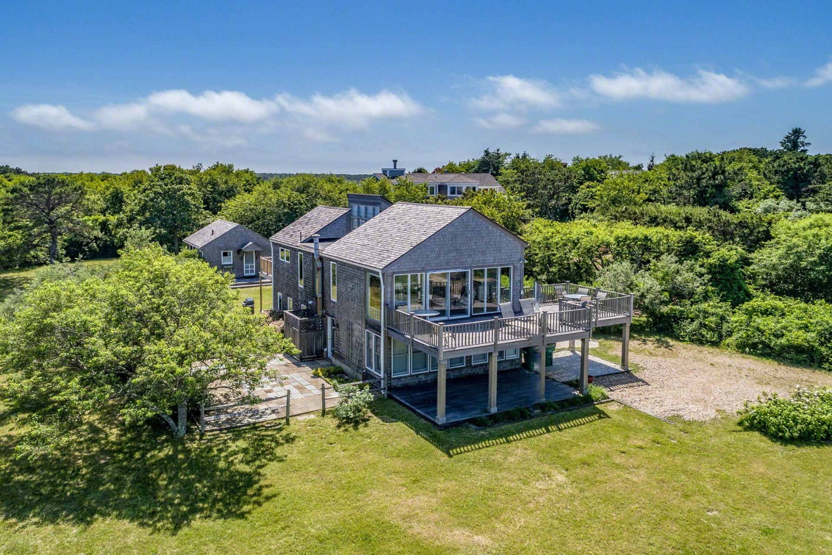 an aerial view of a house with swimming pool patio and fire pit
