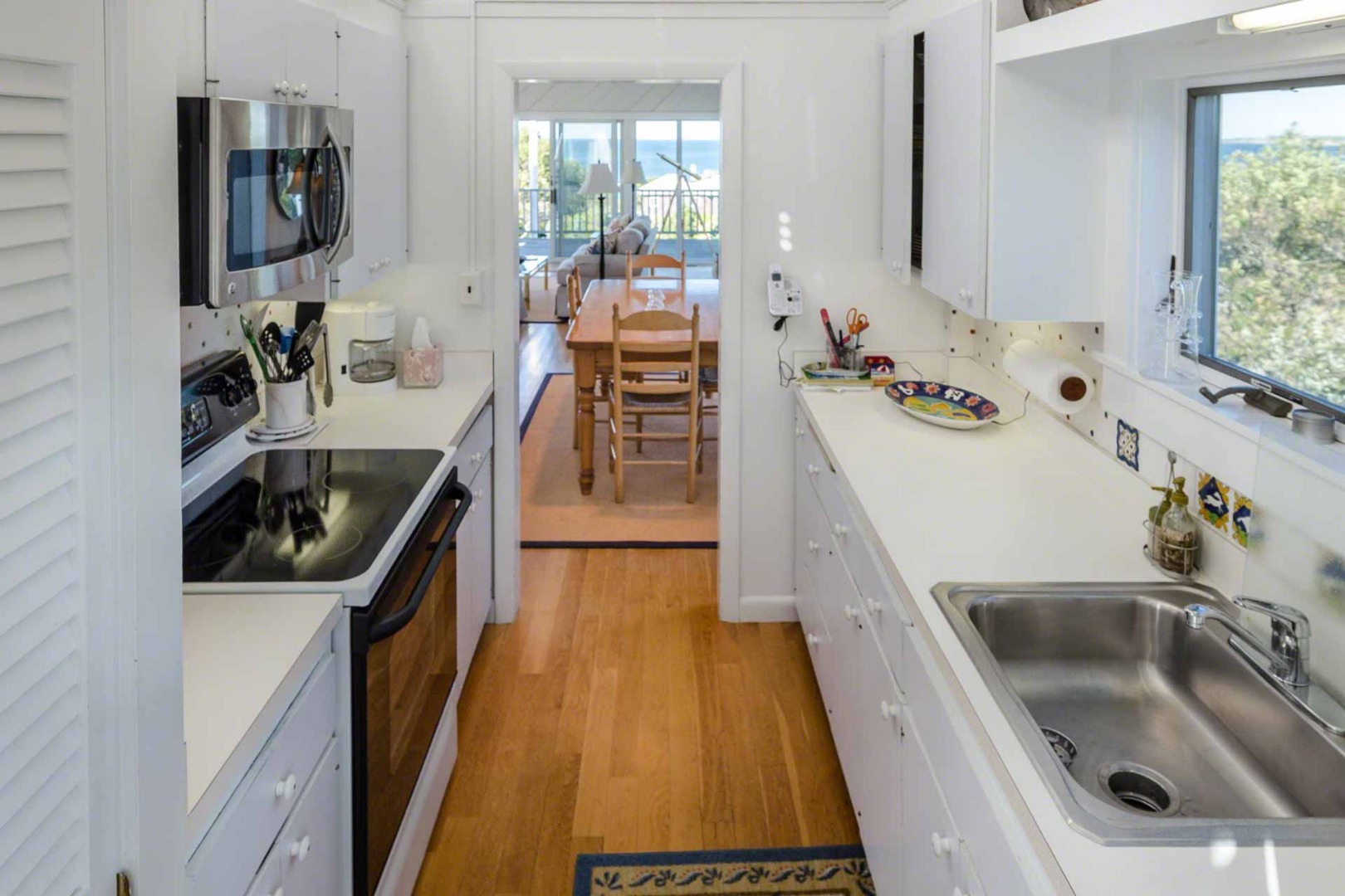 24 Manaca Hill Road Edgartown, MA 02539 - Photo 12 of 34 a kitchen with a sink a faucet a washer and dryer