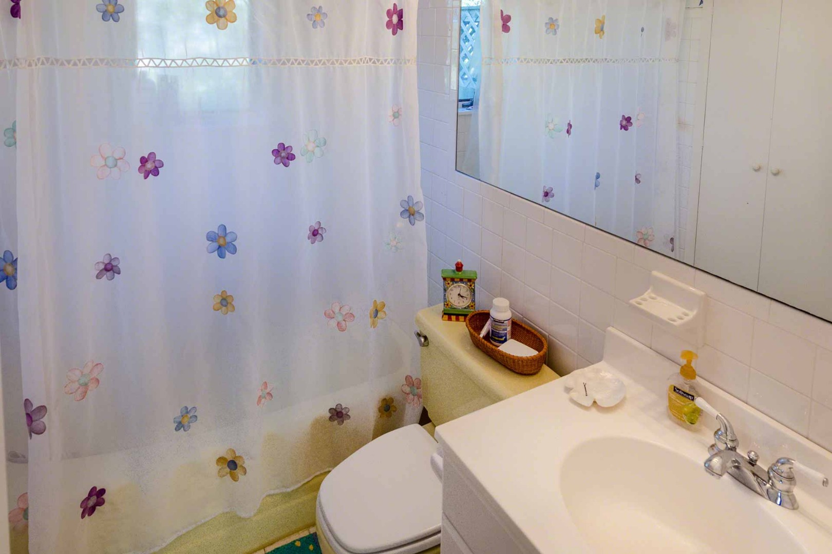 24 Manaca Hill Road Edgartown, MA 02539 - Photo 20 of 34 a bathroom with a sink a toilet and shower curtain