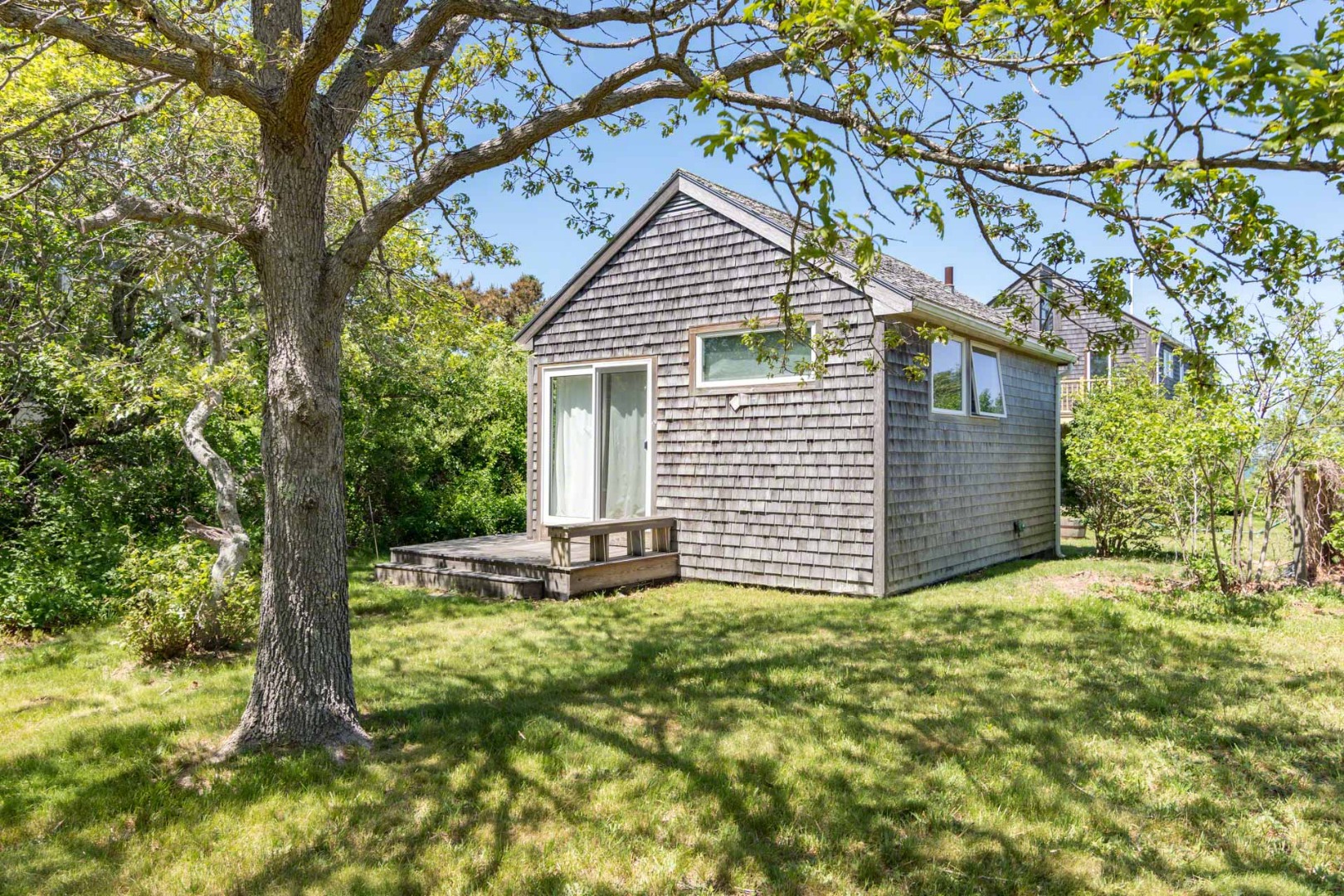 24 Manaca Hill Road Edgartown, MA 02539 - Photo 22 of 34 a front view of a house with a yard and garage
