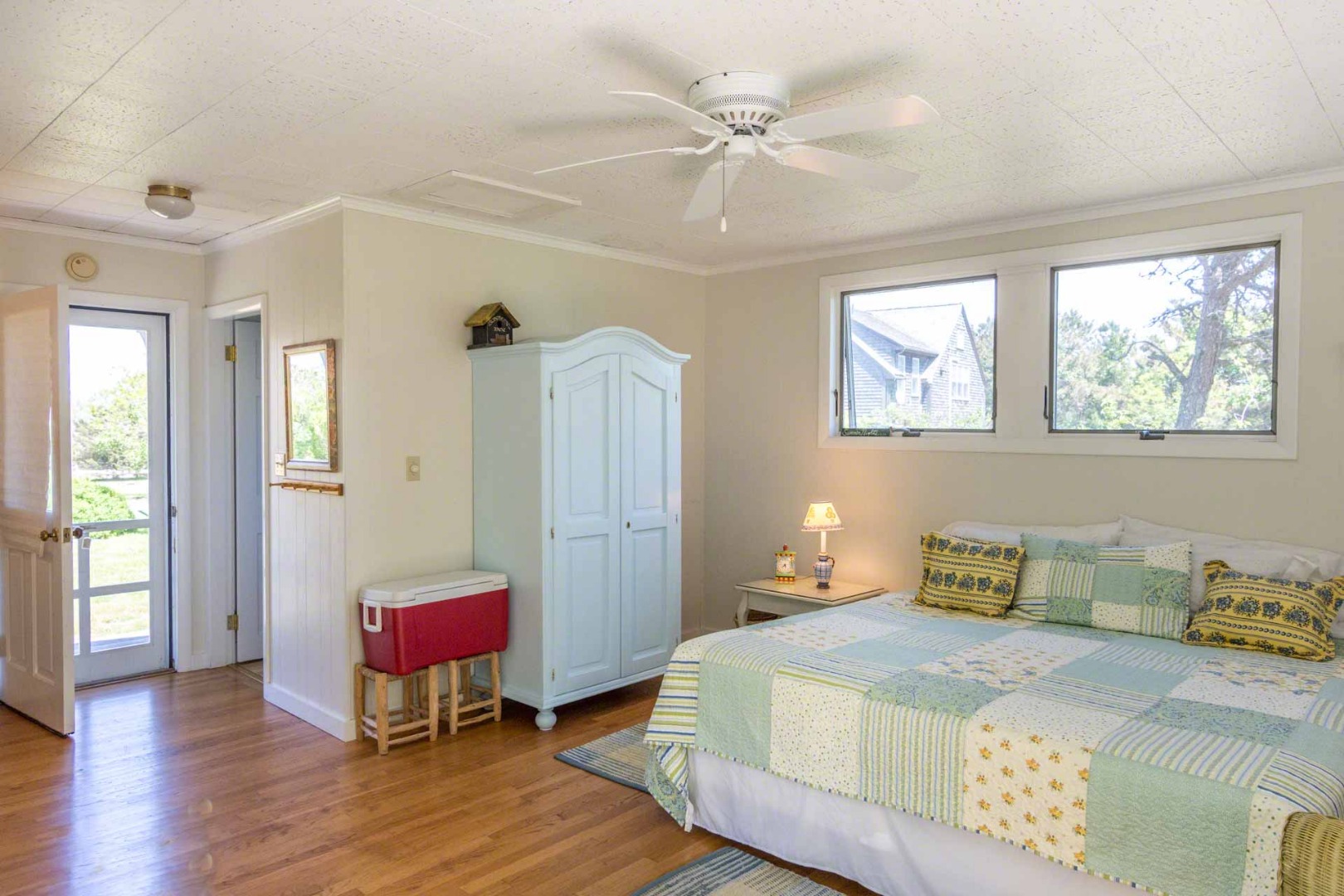 24 Manaca Hill Road Edgartown, MA 02539 - Photo 23 of 34 a bedroom with a bed a table and wooden floor