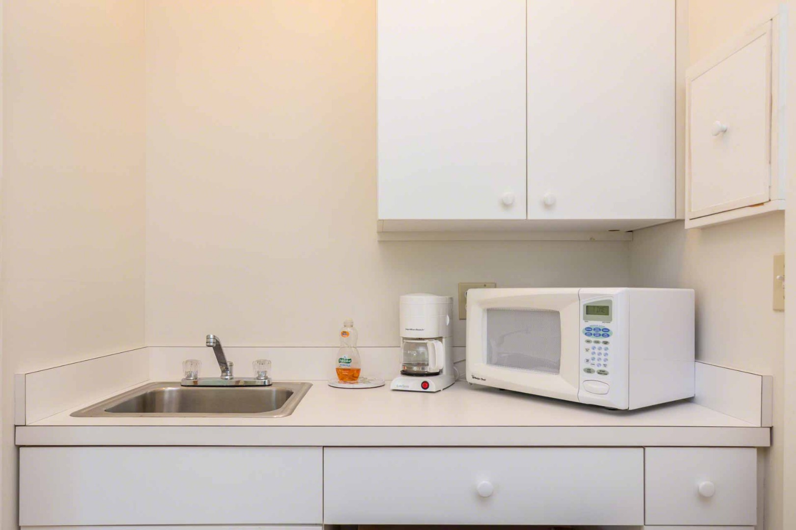 24 Manaca Hill Road Edgartown, MA 02539 - Photo 25 of 34 a kitchen with a sink and cabinets