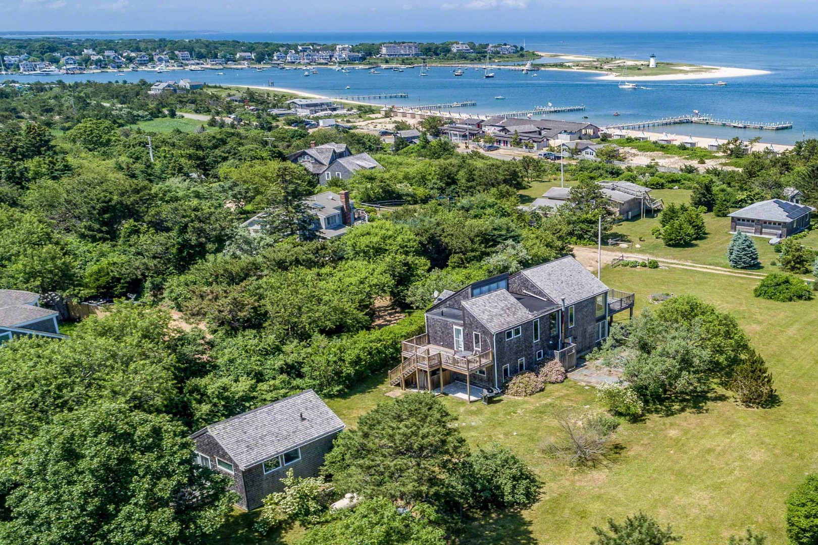 24 Manaca Hill Road Edgartown, MA 02539 - Photo 3 of 34 an aerial view of a house with a garden and lake view