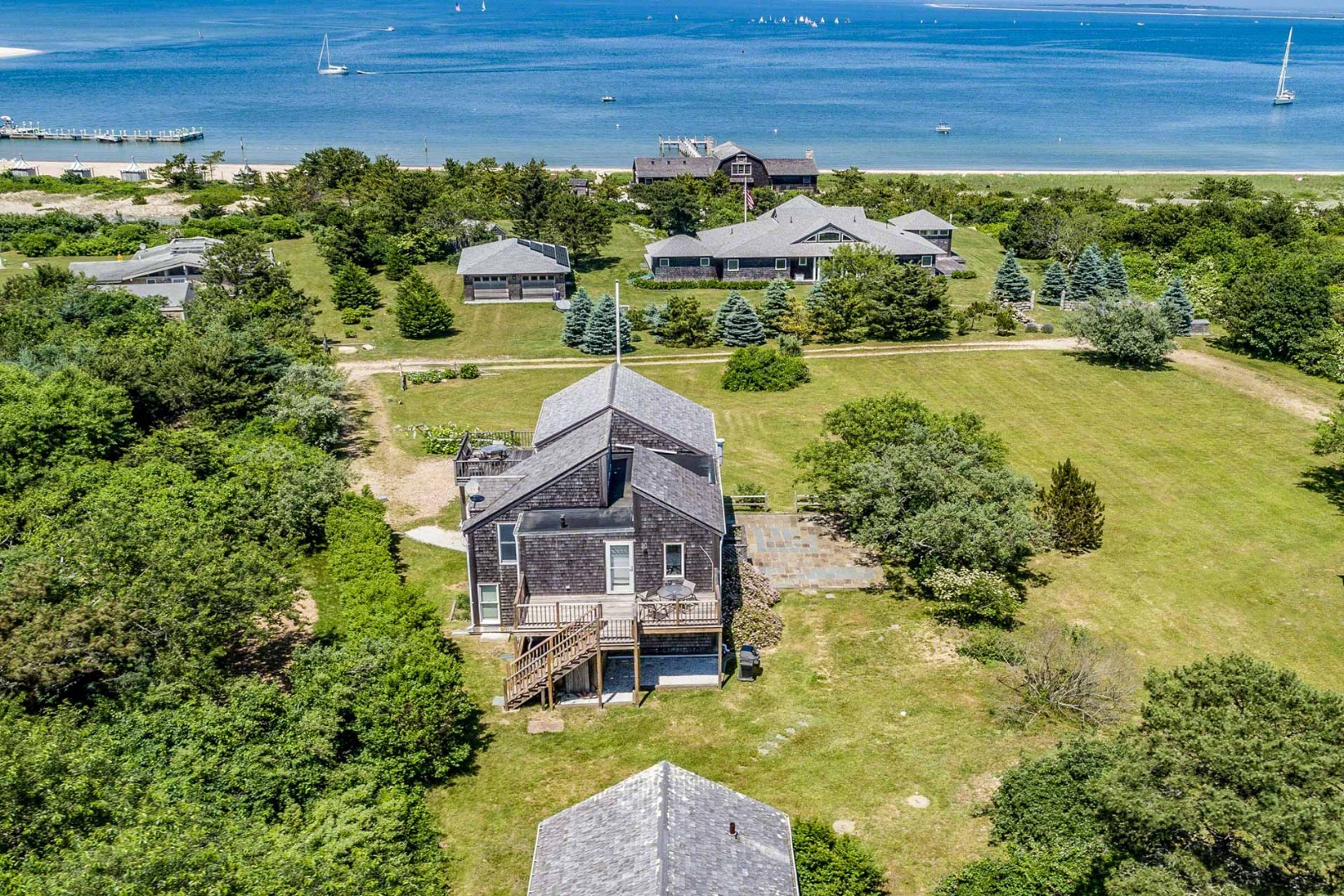 24 Manaca Hill Road Edgartown, MA 02539 - Photo 31 of 34 a aerial view of a house with a big yard