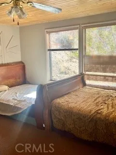 a bed sitting in a bedroom next to a window