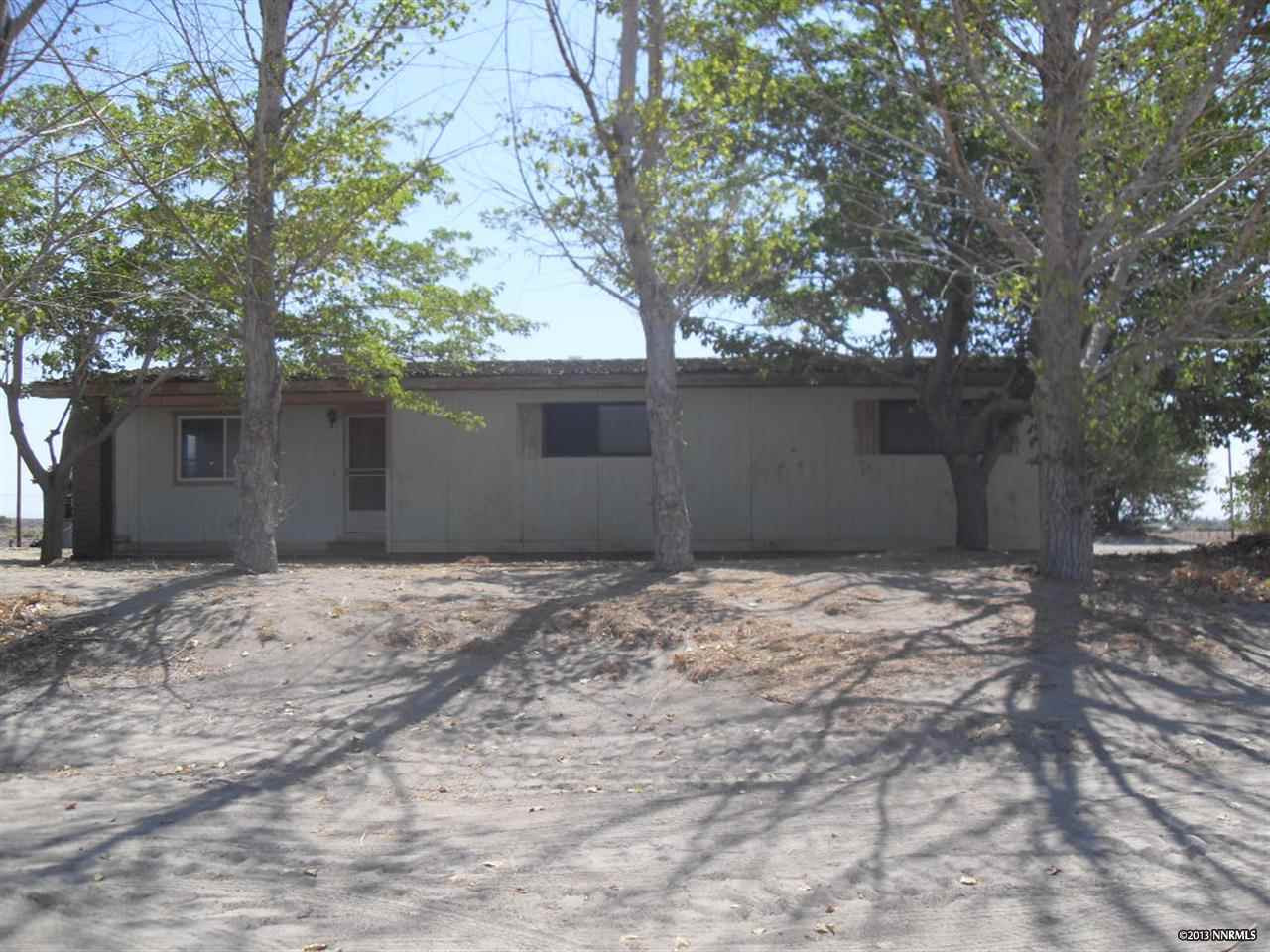 2700 Lucas Road Fallon, NV 89406 - Photo 1 of 1 a house with trees in front of it