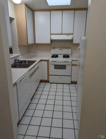 a kitchen with a white cabinets and white appliances
