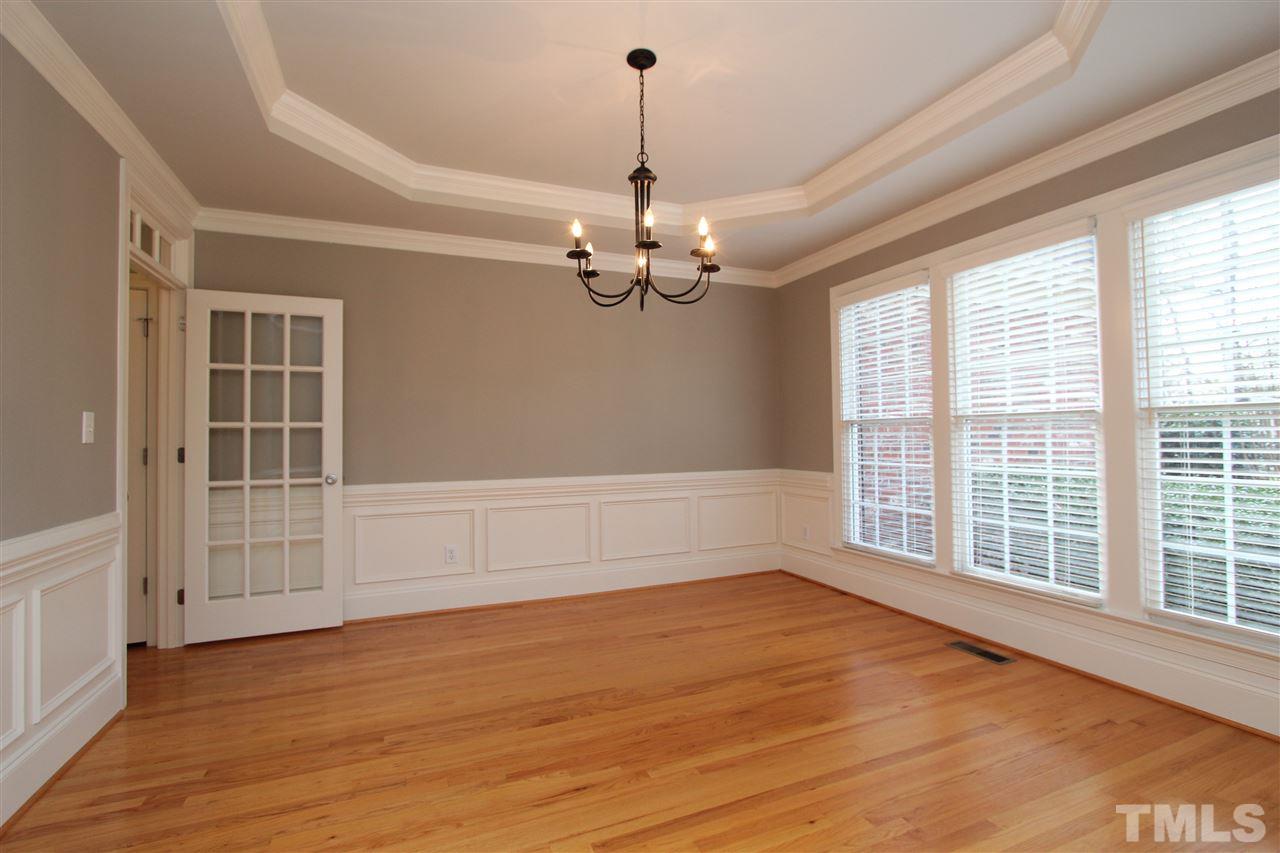 7121 Trenton Ridge Court Raleigh, NC 27613 - Photo 2 of 25 a view of an empty room with a window and wooden floor