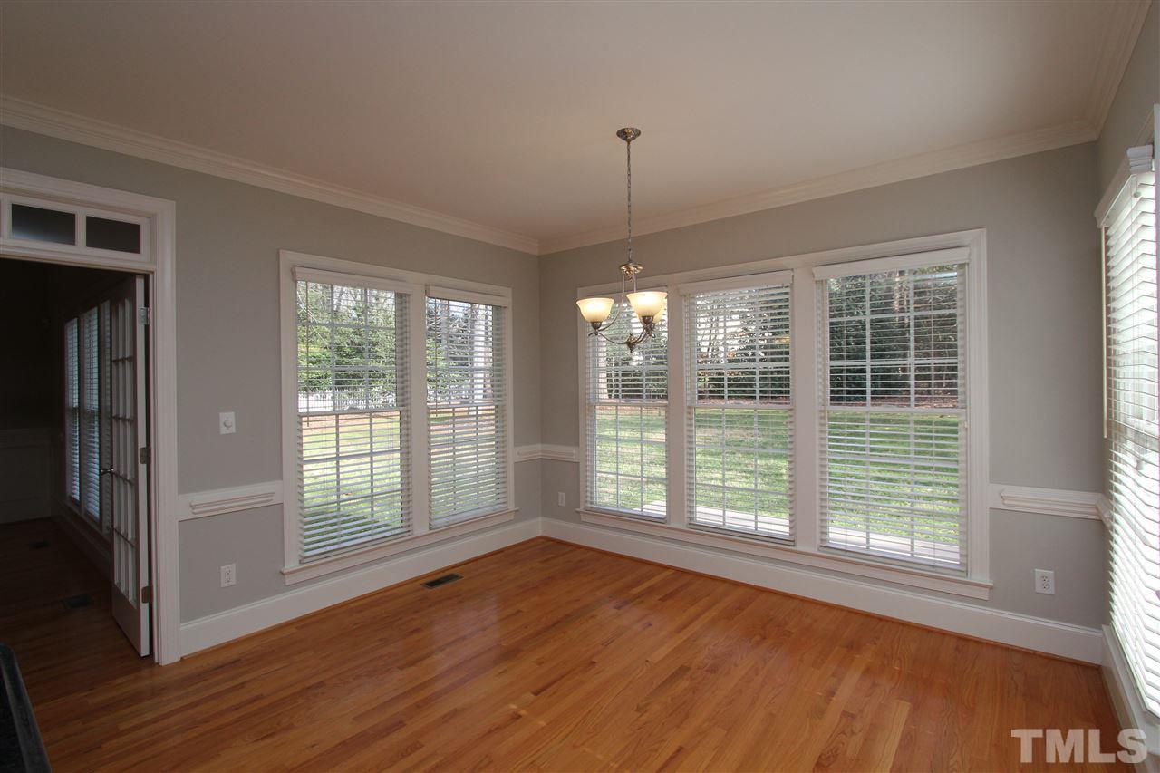7121 Trenton Ridge Court Raleigh, NC 27613 - Photo 11 of 25 a view of an empty room with wooden floor and a window