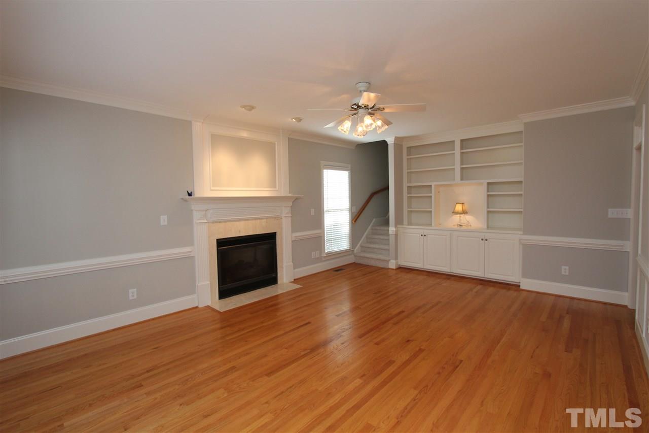 7121 Trenton Ridge Court Raleigh, NC 27613 - Photo 13 of 25 wooden floor fireplace and natural light in room