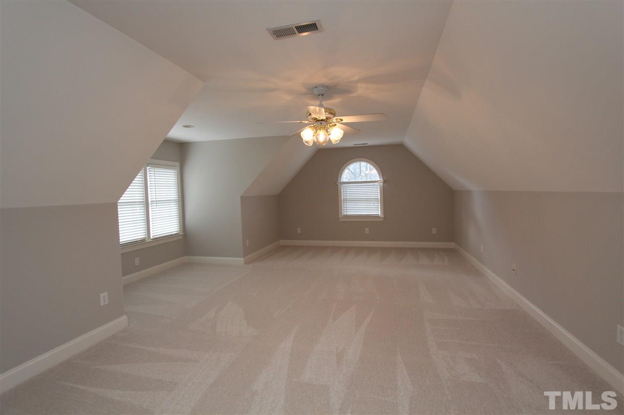 7121 Trenton Ridge Court Raleigh, NC 27613 - Photo 19 of 25 an empty room with windows and fan