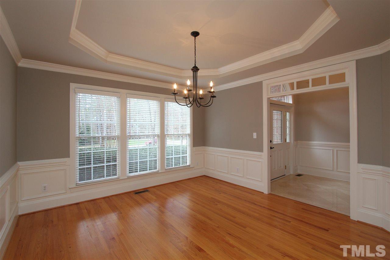 7121 Trenton Ridge Court Raleigh, NC 27613 - Photo 3 of 25 a view of an empty room with wooden floor and a window