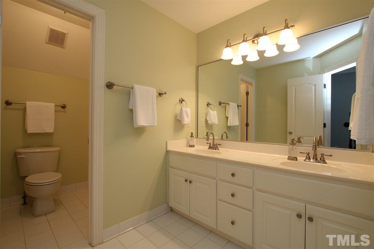 7121 Trenton Ridge Court Raleigh, NC 27613 - Photo 21 of 25 a bathroom with a double vanity sink and a mirror