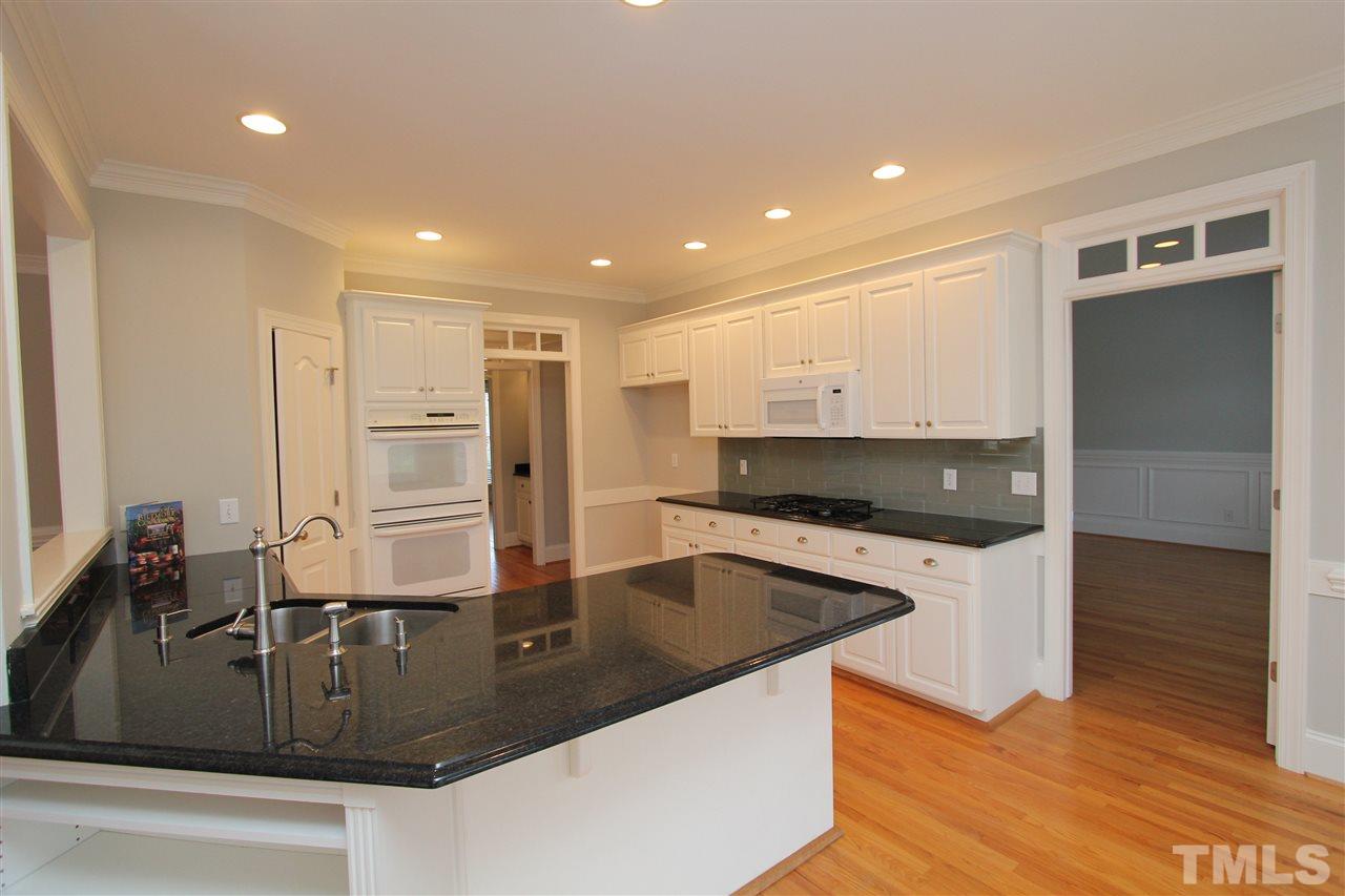 7121 Trenton Ridge Court Raleigh, NC 27613 - Photo 22 of 25 a kitchen with stainless steel appliances granite countertop a sink and a stove