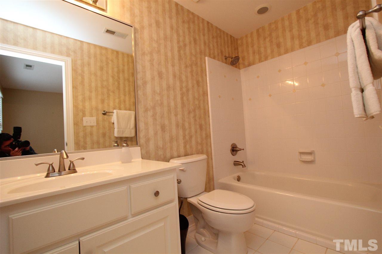 7121 Trenton Ridge Court Raleigh, NC 27613 - Photo 24 of 25 a bathroom with a sink a toilet and shower